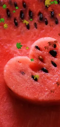 This live wallpaper features a mouth-watering and vibrant close-up of a watermelon slice forming a heart shape
