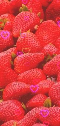 This phone live wallpaper showcases a stunning and realistic close up of a bunch of ripe and juicy strawberries