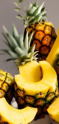 This stunning phone live wallpaper showcases a vibrant pile of pineapples and bananas on a transparent background
