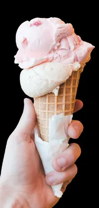 This live phone wallpaper offers a close-up image of a hand holding an ice cream cone