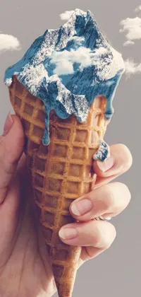 This phone live wallpaper showcases a close-up of an ice cream cone atop a blue waffle cone