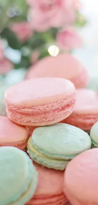 This phone live wallpaper features a stunning close-up of a plate of colorful macarons arranged on a pristine table