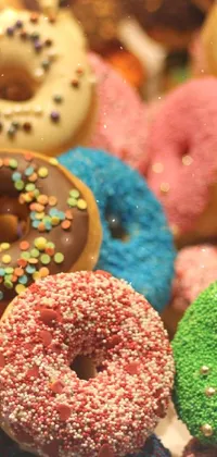 Indulge your sweet cravings with this phone live wallpaper featuring a scrumptious pile of assorted donuts with colorful sprinkles