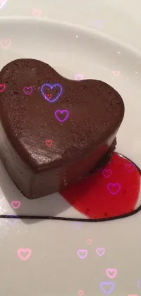 Indulge in the sweet decadence of a heart-shaped chocolate dessert on a white plate with this live wallpaper