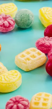 This colorful phone live wallpaper features a fun and vibrant table adorned with jelly-covered waffles and ripe raspberries