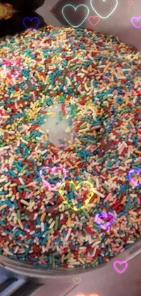 This lively phone live wallpaper features a pan of sprinkles atop a stove, complemented by a festive mix of colors including pink, blue, purple, and yellow