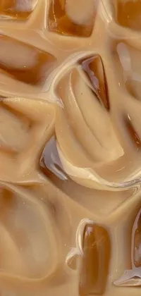 This phone live wallpaper features a realistic close-up painting of a bowl of ice cream with caramel sauce by an accomplished artist