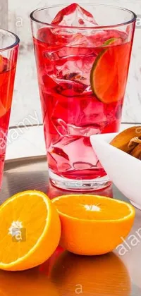 This stunning phone live wallpaper showcases two glasses of delicious red wine accompanied by almonds and oranges on a silver tray