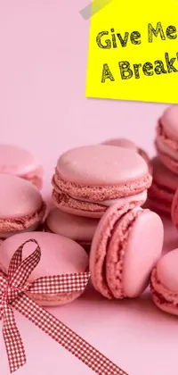 This live wallpaper showcases a stunning image of pink macarons with a playful note that reads "Give me a break"