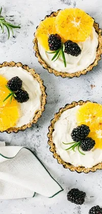 This stunning live wallpaper features a mouth-watering display of a blackberry and orange tart with a hint of tartness, set against a renaissance-inspired flat lay background