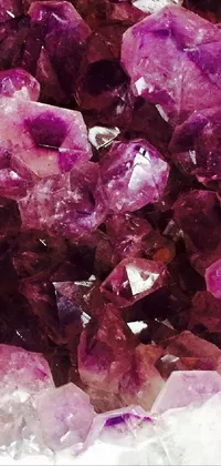 This phone live wallpaper features a stunning pile of purple crystals on a table