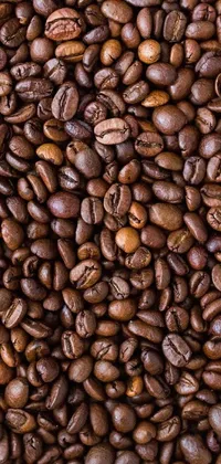 This coffee-themed live wallpaper features a pile of beans viewed from above, set against a warm and inviting coffee shop counter background