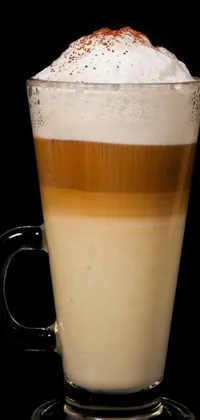 This coffee-themed live wallpaper displays a steaming cup of coffee topped with fluffy whipped cream and a spoon resting on the cup's edge