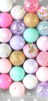 This phone live wallpaper features a plastic container filled with colorful eggs adorned with glitter and unique patterns