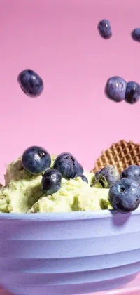 This phone live wallpaper showcases a bowl of creamy ice cream with juicy blueberries, captured in hyperrealistic detail with green and purple lighting