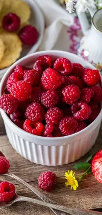 Enhance your home screen with this appealing live wallpaper! You'll be greeted with a mouth-watering bowl of refreshing raspberries resting on a natural wooden table at every glance