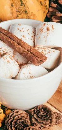 This live phone wallpaper features a rustic and charming still-life image of a hot chocolate cup adorned with marshmallows and cinnamon
