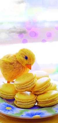 This live wallpaper for your phone features a delightful yellow bird perched on a stack of mouth-watering cookies