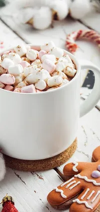 This phone live wallpaper features a cozy cup of hot chocolate with marshmallows and ginger cookies