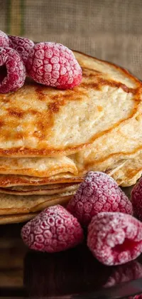 Looking for a sleek and sophisticated live wallpaper for your phone? Look no further than this stunning image of fluffy pancakes and fresh raspberries