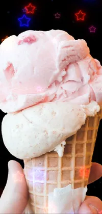 This phone live wallpaper features a close-up photo of a person holding an ice cream cone on a black background
