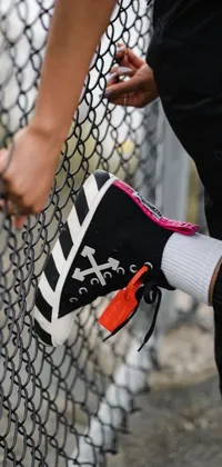 This live wallpaper is a dynamic combination of elements including a tennis racket, urban graffiti sourced from Unsplash, a brightly-colored lego sneaker from the Off-White collection, and a close-up of a hand holding a phone