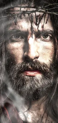 This dynamic phone live wallpaper features an iconic portrait resembling Jesus Christ with a crown of thorns on his head