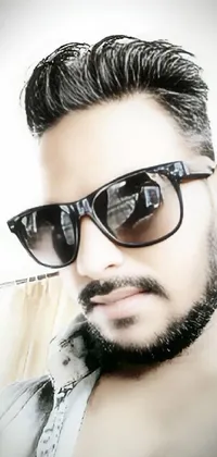 This live wallpaper features an androgynous person with a beard and sunglasses, posing for the camera in a profile picture style