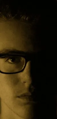 This phone live wallpaper showcases a stunning close-up image of a person wearing glasses with a duotone color scheme