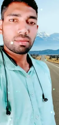 This phone live wallpaper features a captivating image of a man taking a selfie on the side of the road