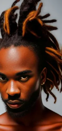 This mobile live wallpaper features a close-up of a person with styled dreads and vivid orange braided hair