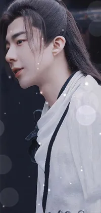 Enhance your phone's aesthetics with this beautiful live wallpaper featuring a close-up of a person wearing a crisp white shirt