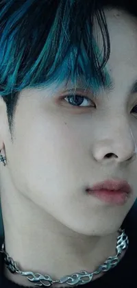 This stunning phone live wallpaper features a beautiful close-up of a person with striking blue hair and piercing amber eyes