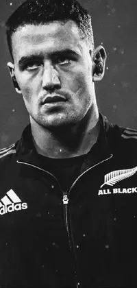 This stunning phone live wallpaper features an intense black and white photo of a rugby player charging towards his opponents