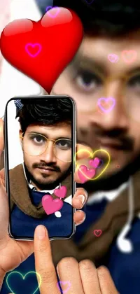 This phone live wallpaper depicts a modern, sleek cell phone displaying a heart-shaped portrait photograph profile picture in striking high definition