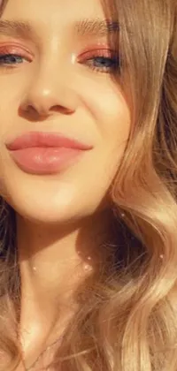 This phone live wallpaper showcases a captivating close-up of a woman with long blonde hair and blush pink lips