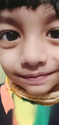 This live wallpaper features a beautiful close-up image of a child wearing a vibrant scarf