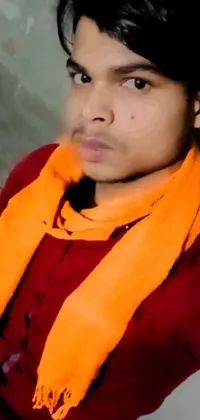 This phone live wallpaper showcases a striking image of a person wearing a scarf, against an oversaturated background
