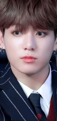 This live wallpaper features a close up of a person wearing a suit and tie with round ears, clear clean face, and dangling earring