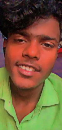 This phone live wallpaper showcases a close-up of a young man with dark skin wearing a green shirt, while a faded image of a real engine is in the background