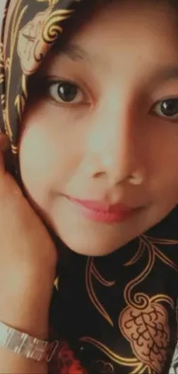 This phone live wallpaper showcases a close-up shot of a person wearing a headscarf and is inspired by Sumatraism