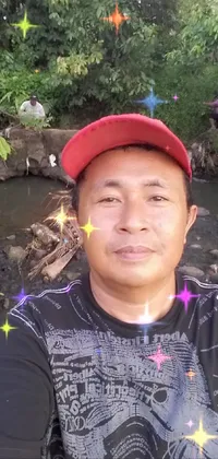This is a vibrant live wallpaper for phones, featuring a man wearing a red hat taking a selfie with his mobile device while standing near a beautiful creek in the Sumatra region
