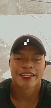 This stunning live phone wallpaper showcases a close-up of a Southeast Asian individual donning a hat