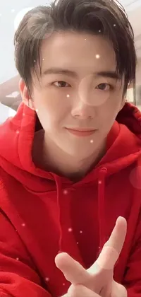 This phone live wallpaper showcases a vibrant red hoodie, with a close-up shot of the person's face cropped below the eyes