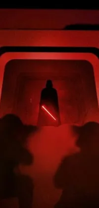 This live wallpaper showcases a group of individuals standing in a dark tunnel, illuminated by the striking red lightsaber at the center of the scene