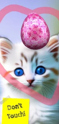This phone live wallpaper showcases an adorable white kitten with a fluffy pink ball on its head, perfect for adding a touch of whimsy and cuteness to your device