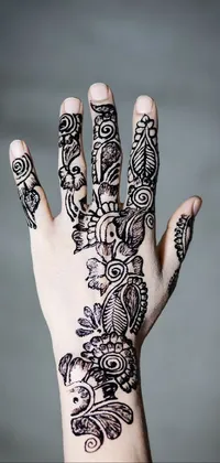 This live wallpaper depicts a close-up of a hand adorned with henna tattoos