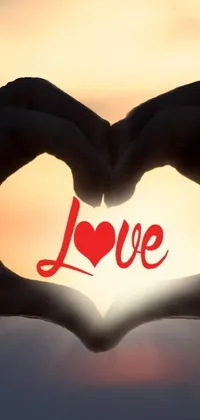 This beautiful live phone wallpaper depicts a heart shaped hand gesture, representing love and romanticism