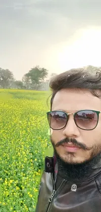 This stunning live wallpaper features a young man taking a selfie in a vibrant yellow field