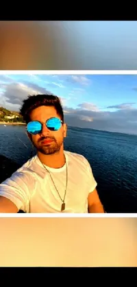 This live wallpaper showcases an actor taking a trendy selfie in front of the ocean, with Hurufiyya-inspired clothing and mirrored sunglasses